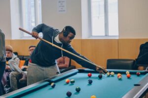Picture of student playing pool in the games room