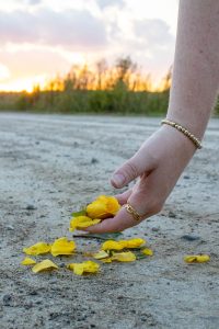 The other person picking up the stepped on flower.