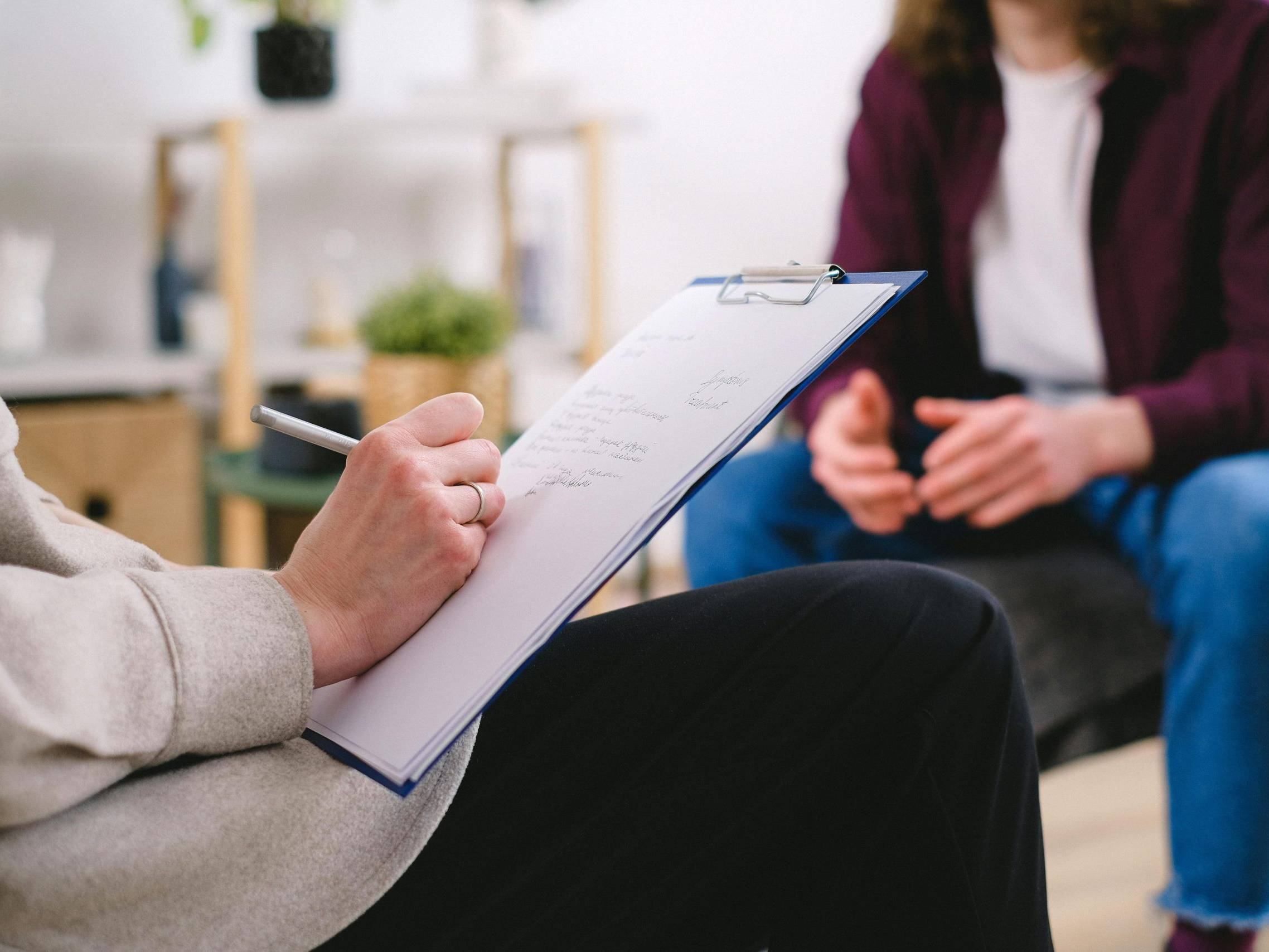 A Therapist Writing on a Paper