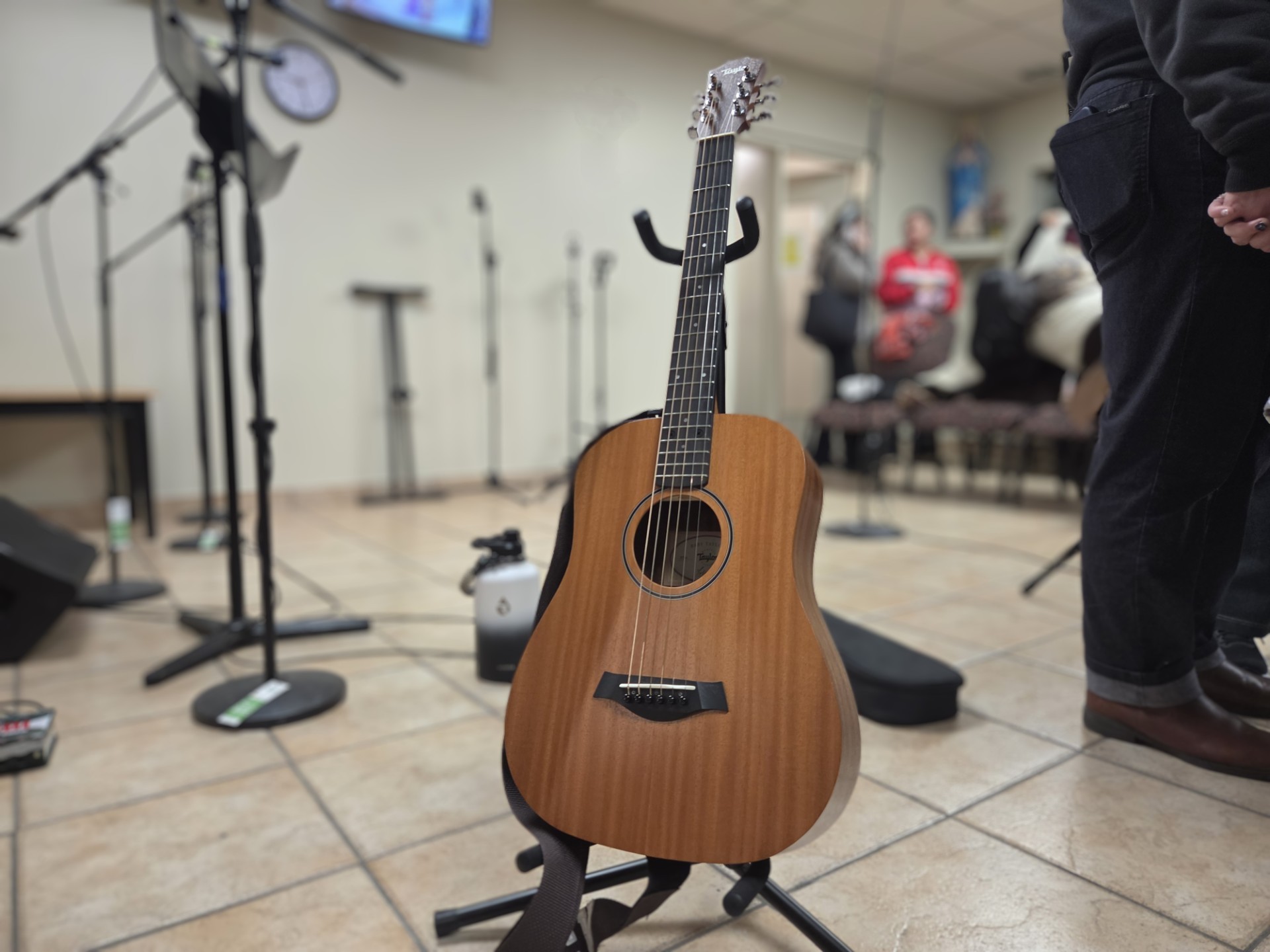 A guitar sitting on a stand.